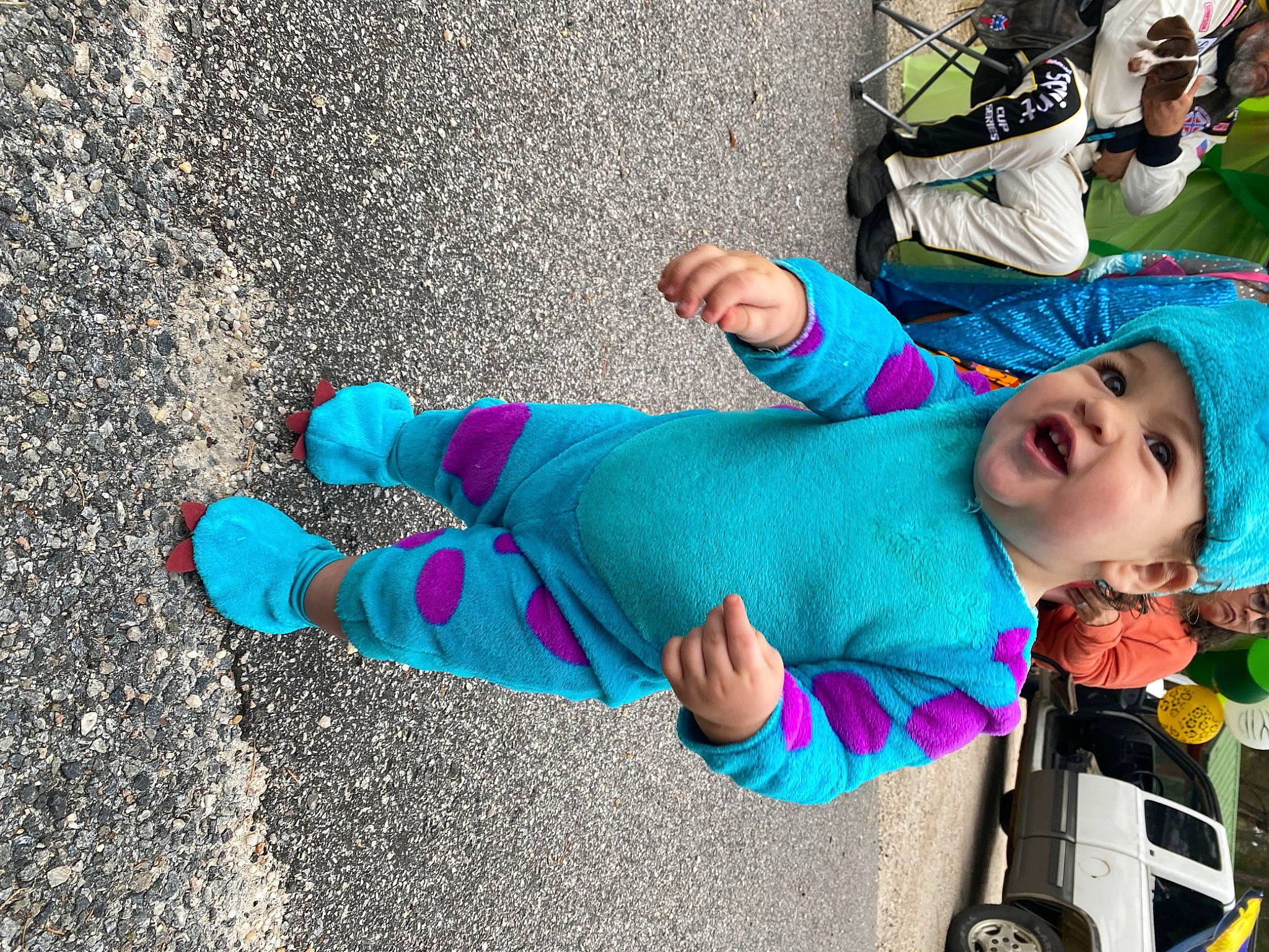 Layton is registered to the contest to win money with this photo: asphalt, azure, child, costume, electric_blue, eyewear, fun, grass, green, happy, headwear, human_leg, leisure, person, play, recreation, road, street, sunglasses, tire