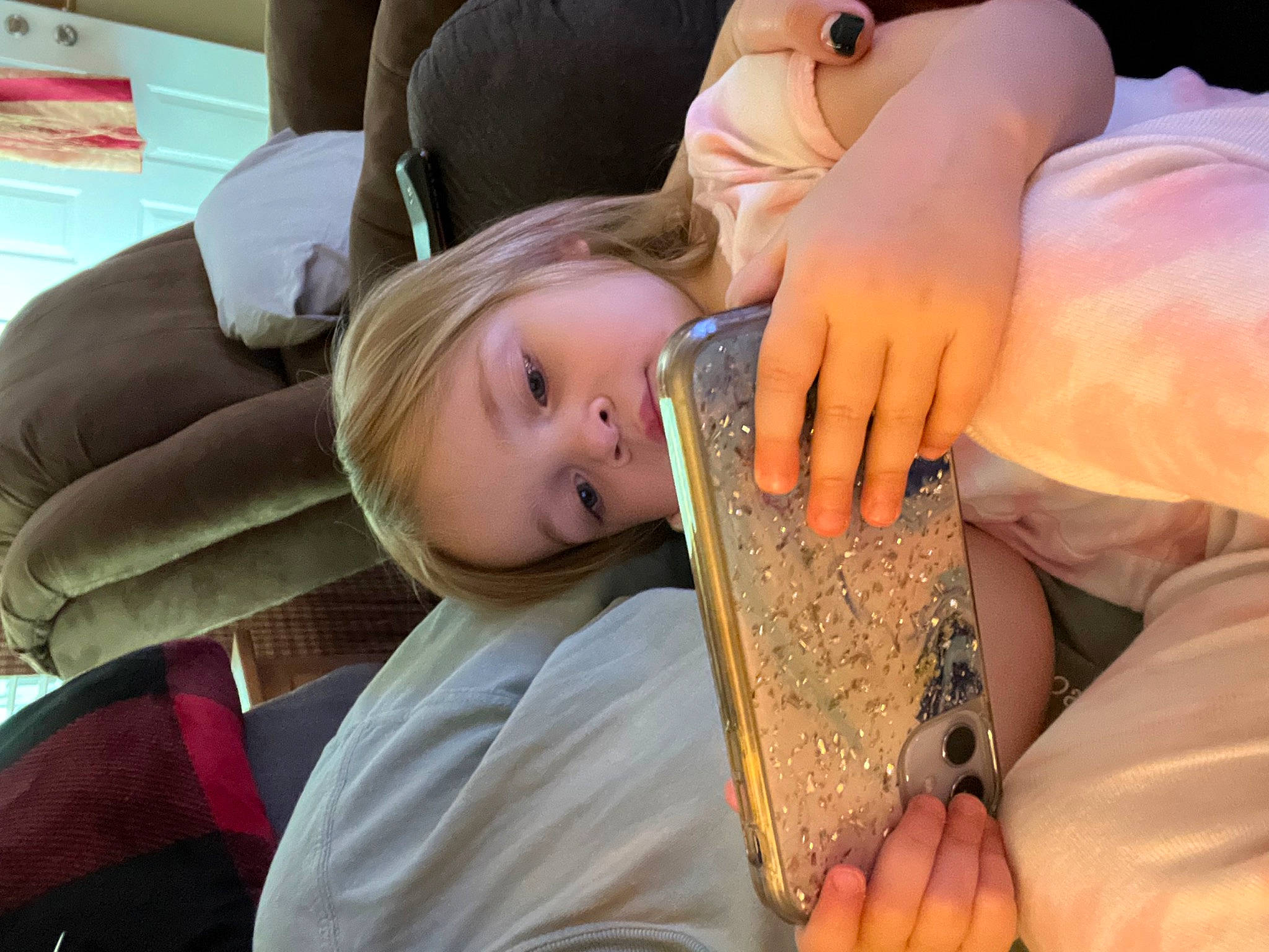 Mckinley is registered to the contest to win money with this photo: arm, child, comfort, couch, finger, fun, gesture, hairstyle, happy, head, human_leg, leisure, nail, person, sitting, thigh, thumb, toddler, wood, wrist