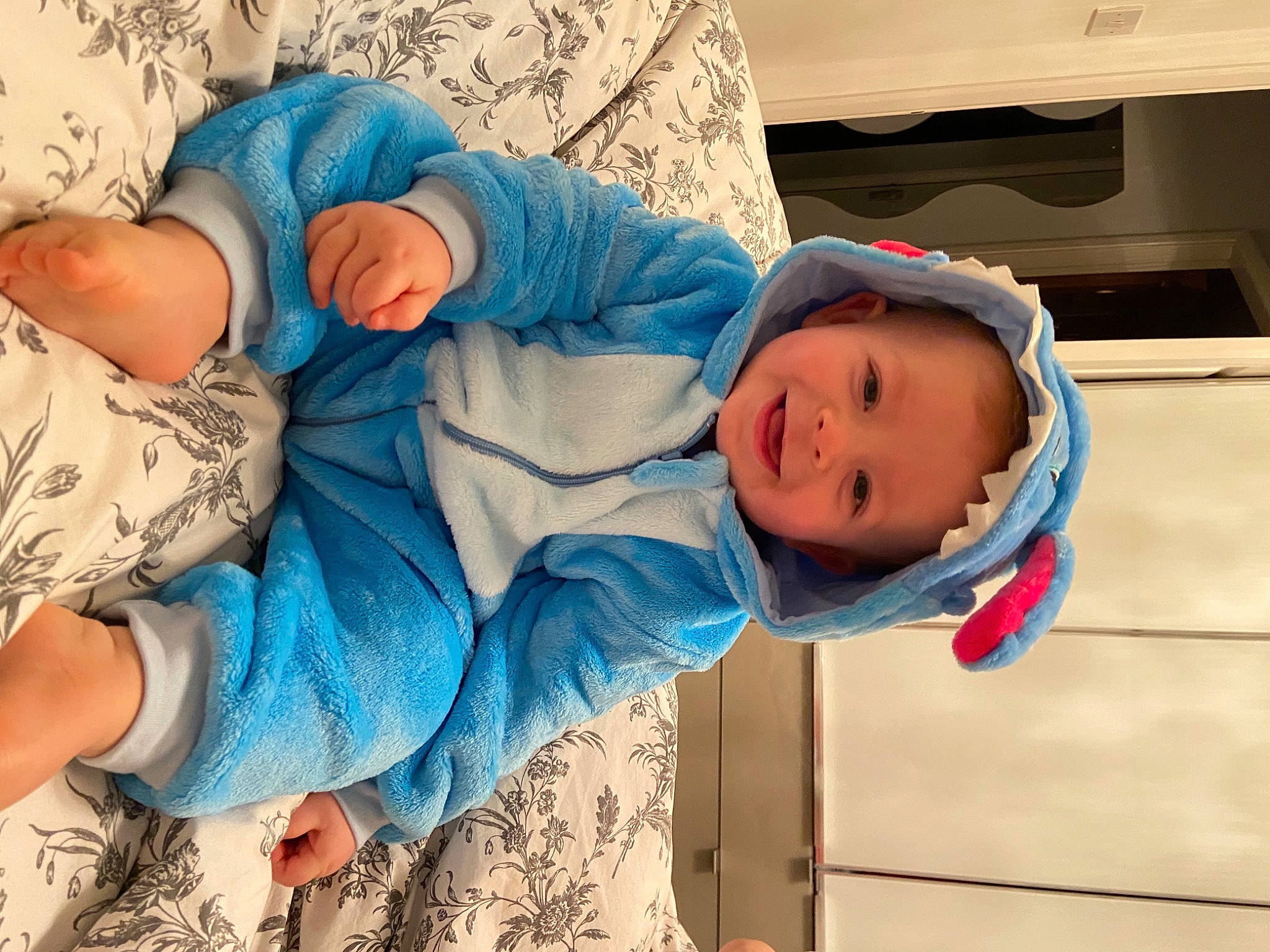 Ossian is registered to the contest to win money with this photo: azure, baby, baby_products, baby_sleeping, baby_toddler_clothing, child, comfort, happy, hat, headwear, joy, linens, nap, pattern, person, room, sitting, skin, smile, toddler