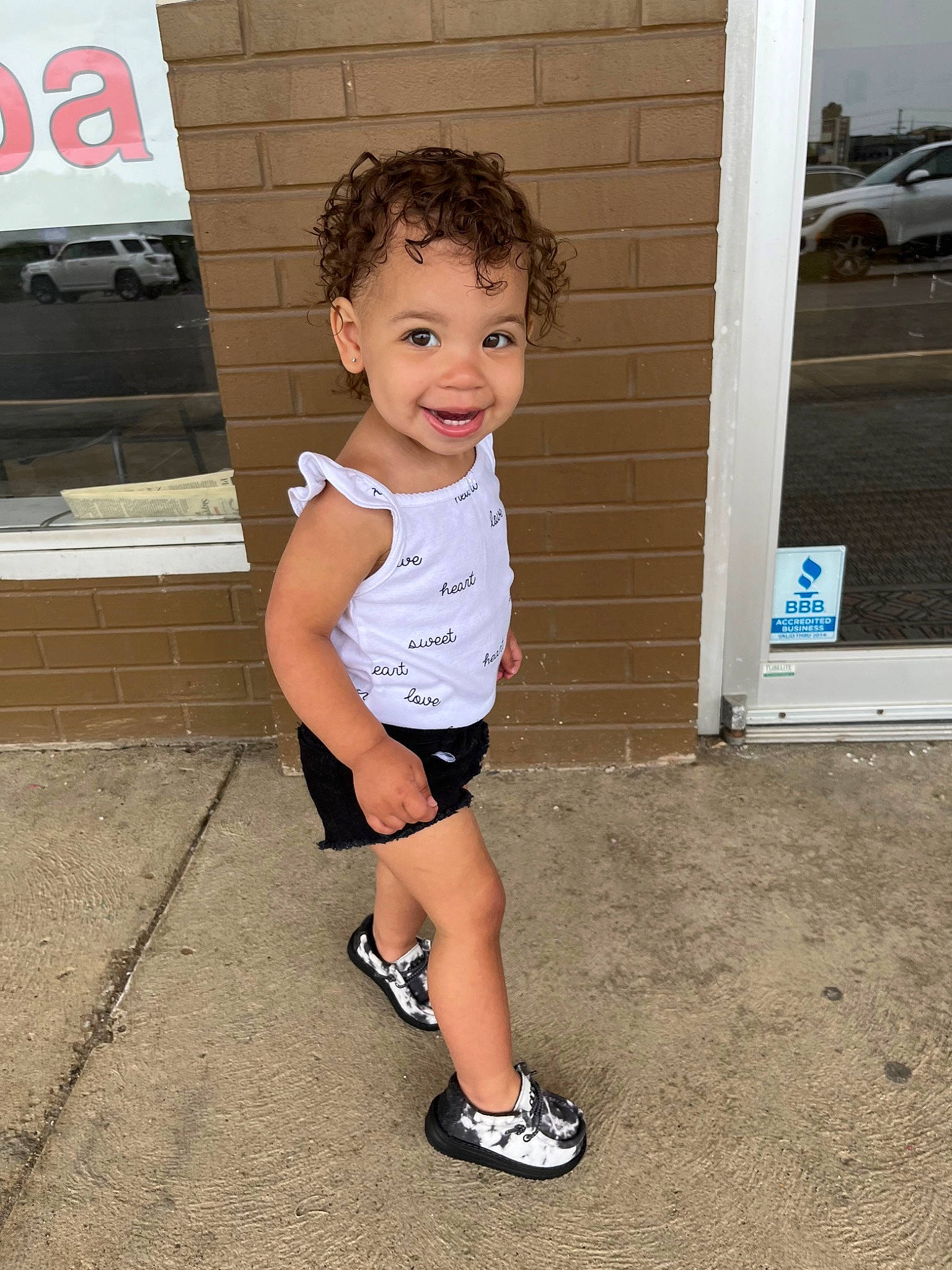 Kyleigh is registered to the contest to win money with this photo: asphalt, baby_toddler_clothing, child, cool, electric_blue, facial_expression, happy, human_leg, joint, joy, knee, person, shorts, shoulder, sleeve, smile, standing, t_shirt, thigh, toddler