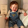 baby, infant, child, smiling, overalls, striped_clothing, socks, armchair, pillow, cozy, indoor, milestone_card, age_card, sunlight, shadow, happy, cute, portrait, person, soft_fabric