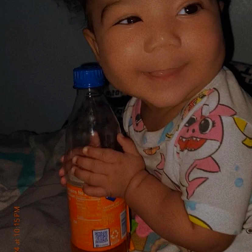 Elli Anni is registered to the contest to win money with this photo: baby, bed, bedroom, beverage, bottle, clothing, face, furniture, happy, head, indoors, juice, person, photography, popbottle, portrait, room, smile, soda, t_shirt