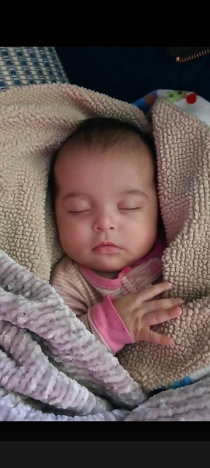 Athena is registered to the contest to win money with this photo: baby, baby_toddler_clothing, cheek, chin, comfort, eye, eyebrow, eyelash, finger, gesture, hand, head, iris, linens, lip, mouth, nose, person, skin, sleeve