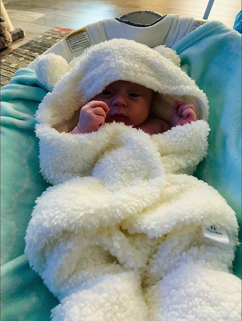 Kian is registered to the contest to win money with this photo: baby, baby_products, baby_sleeping, baby_toddler_clothing, bedding, bedtime, child, comfort, freezing, fur, hat, headwear, linens, nap, nose, person, skin, stuffed_toy, textile, toddler