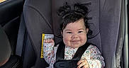 Ahinara joined the competition — help win amazing prizes! baby, car_seat, child, smile, hair_pigtails, safety_harness, clothing, indoors, seatbelt, cute, infant, person, car_interior, foot, happy, portrait, sitting, window, daylight, face