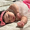 baby, sleeping, pink_bow, headband, pink_pants, tulle_skirt, bedspread, soft_lighting, peaceful, closeup, cute, infant, person, sleep, resting, child, indoors, adorable, relaxed, toddler