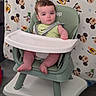 baby, high_chair, child, infant, green, nike, shirt, face, legs, feet, expression, blanket, mickey_mouse, disney, pattern, indoor, seat, strap, person, curious