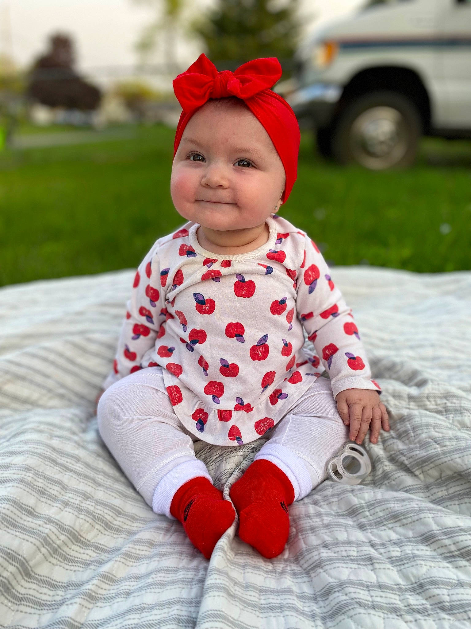 Valencia joined the competition — help win amazing prizes! baby, baby_toddler_clothing, cap, car, face, fun, grass, happy, hat, head, headgear, headwear, joy, outerwear, pattern, person, red, sleeve, smile, textile