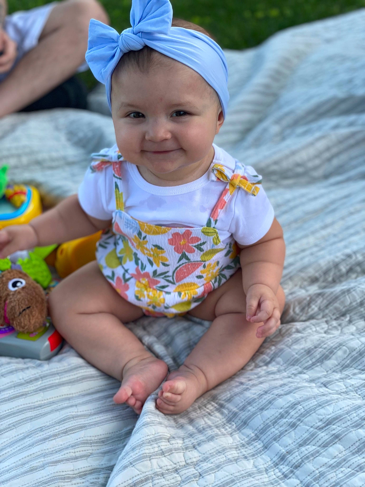 Valencia is registered to the contest to win money with this photo: baby, baby_toddler_clothing, beauty, blue, cap, child, facial_expression, fun, grass, green, happy, headgear, headwear, joy, leaf, pattern, person, photograph, sitting, skin