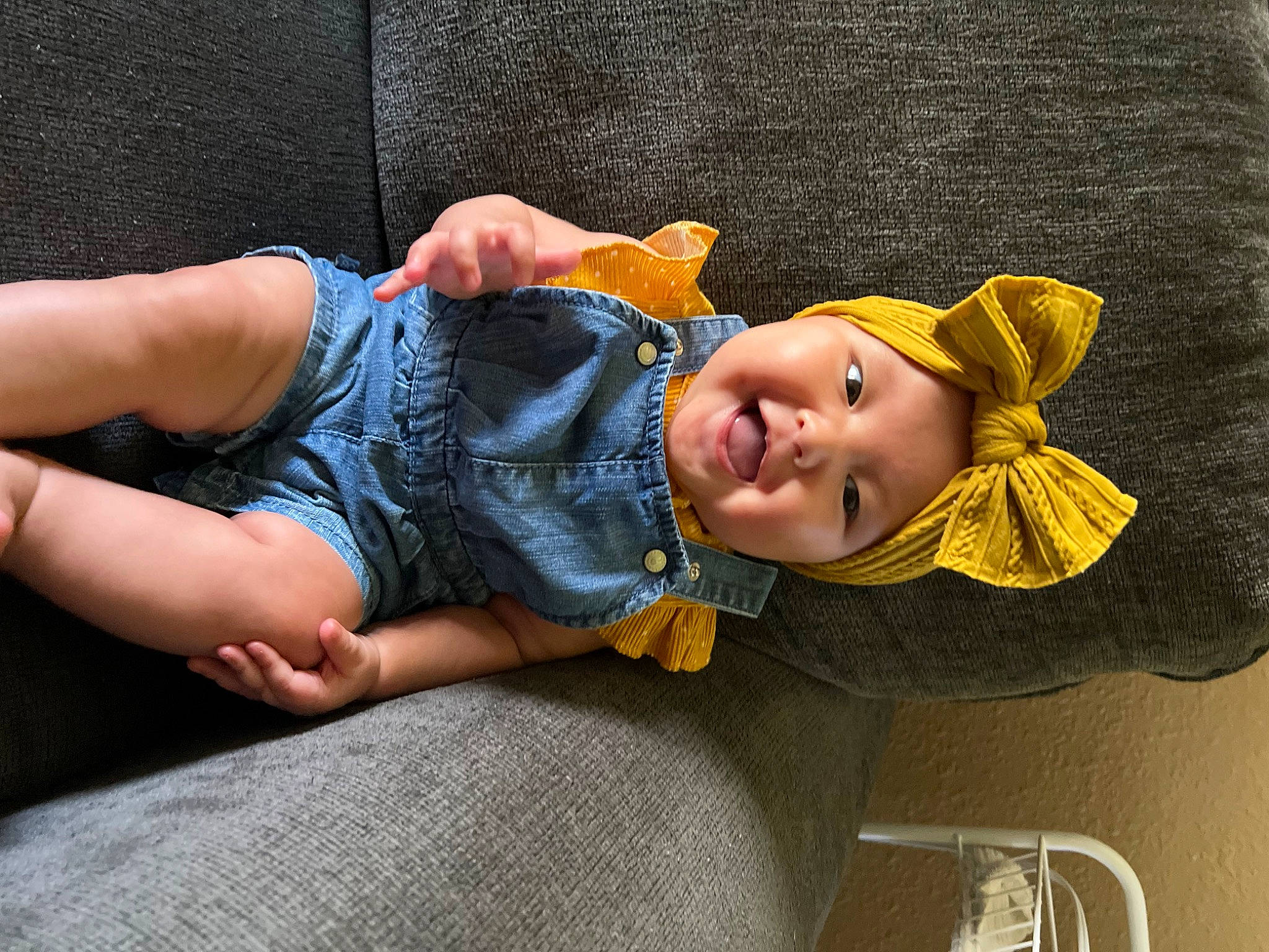Naveah is registered to the contest to win money with this photo: baby, baby_toddler_clothing, cap, child, comfort, denim, electric_blue, eye, fashion_accessory, fun, grass, hat, human_leg, linens, person, sitting, smile, sun_hat, thigh, toddler