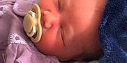 Amani joined the competition — help win amazing prizes! newborn, baby, sleeping, pacifier, blanket, bottle, infant, soft, cozy, rest, child, closeup, indoors, comfort, purple_clothing, peaceful, face, head, cute, portrait