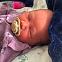 newborn, baby, sleeping, pacifier, blanket, bottle, infant, soft, cozy, rest, child, closeup, indoors, comfort, purple_clothing, peaceful, face, head, cute, portrait