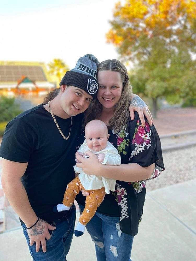 Aubrey is registered to the contest to win money with this photo: baby, eye, family_taking_photos_together, fun, gesture, grass, happy, headwear, interaction, jeans, joy, leisure, people, people_in_nature, person, photograph, plant, recreation, smile, standing