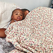 Melody joined the competition — help win amazing prizes! child, baby, blanket, floral_pattern, bed, pillow, adult, sleeping, resting, indoor, person, cozy, comfort, family, portrait, face, head, relaxation, casual, home