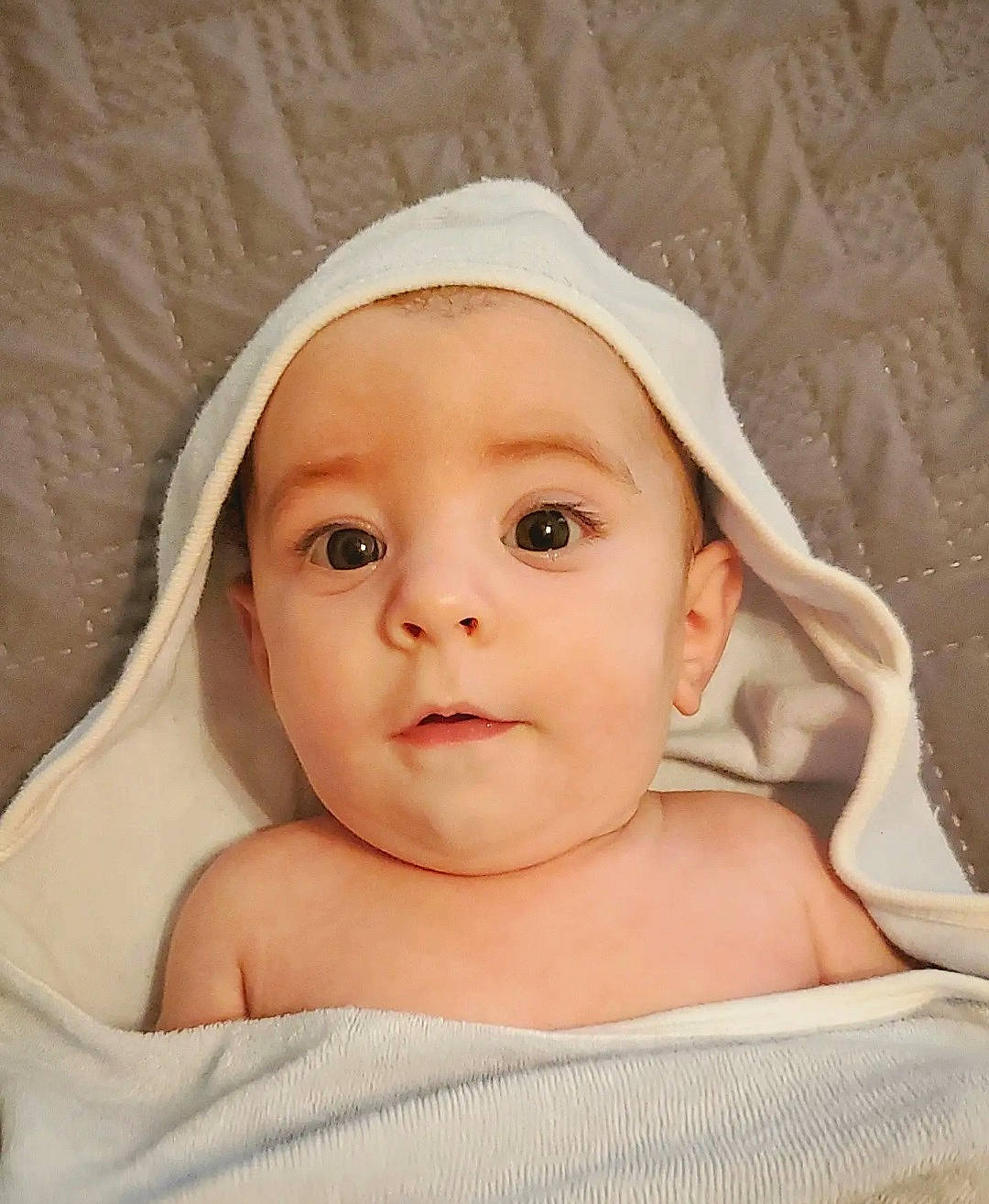 Kaden is registered to the contest to win money with this photo: baby, baby_products, baby_sleeping, baby_toddler_clothing, cheek, child, close_up, comfort, eyebrow, facial_expression, fashion_accessory, linens, peach, person, portrait_photography, skin, sleeve, smile, toddler, towel