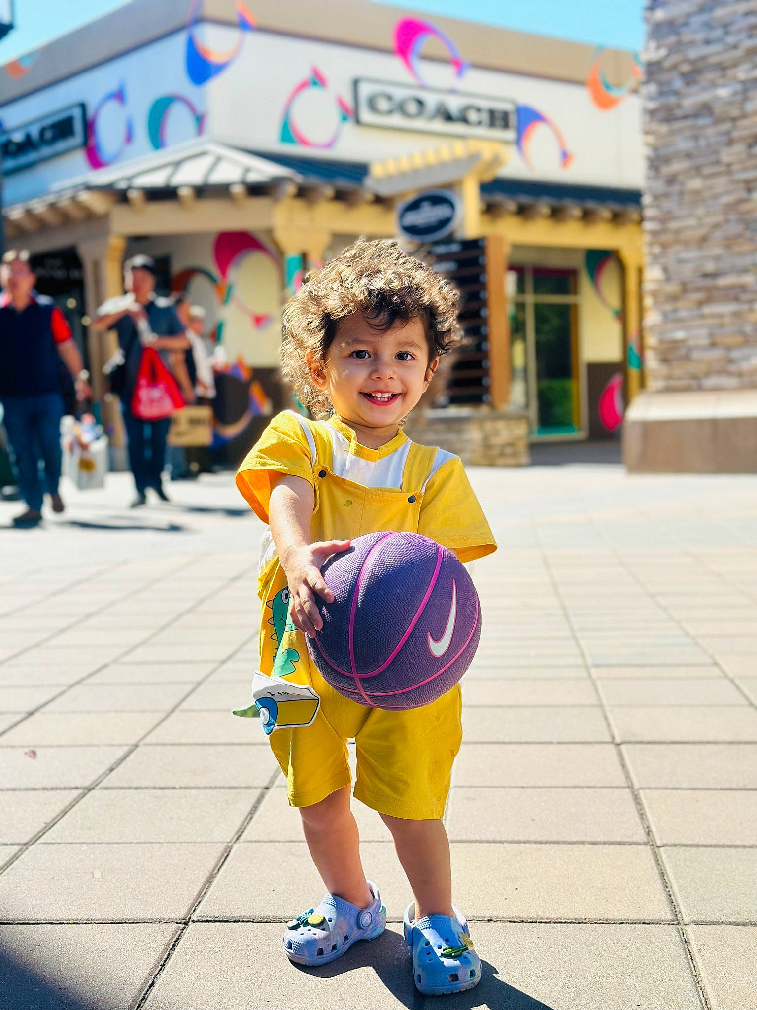 Hawa is registered to the contest to win money with this photo: child, city, entertainment, event, fun, happy, hat, joy, leisure, pedestrian, person, recreation, road, sandal, shorts, smile, sneakers, street, toddler, tourism