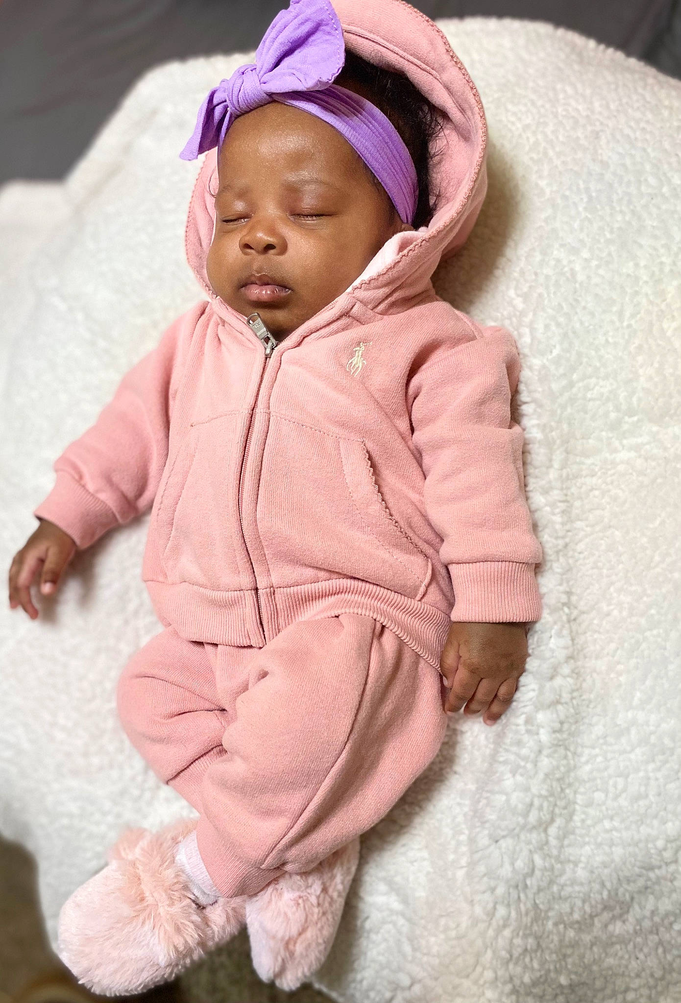 Choyce is registered to the contest to win money with this photo: baby, baby_toddler_clothing, cap, cheek, clothing, comfort, eye, face, hand, head, headgear, human_body, jacket, outerwear, person, pink, skin, sleeve, textile, toddler