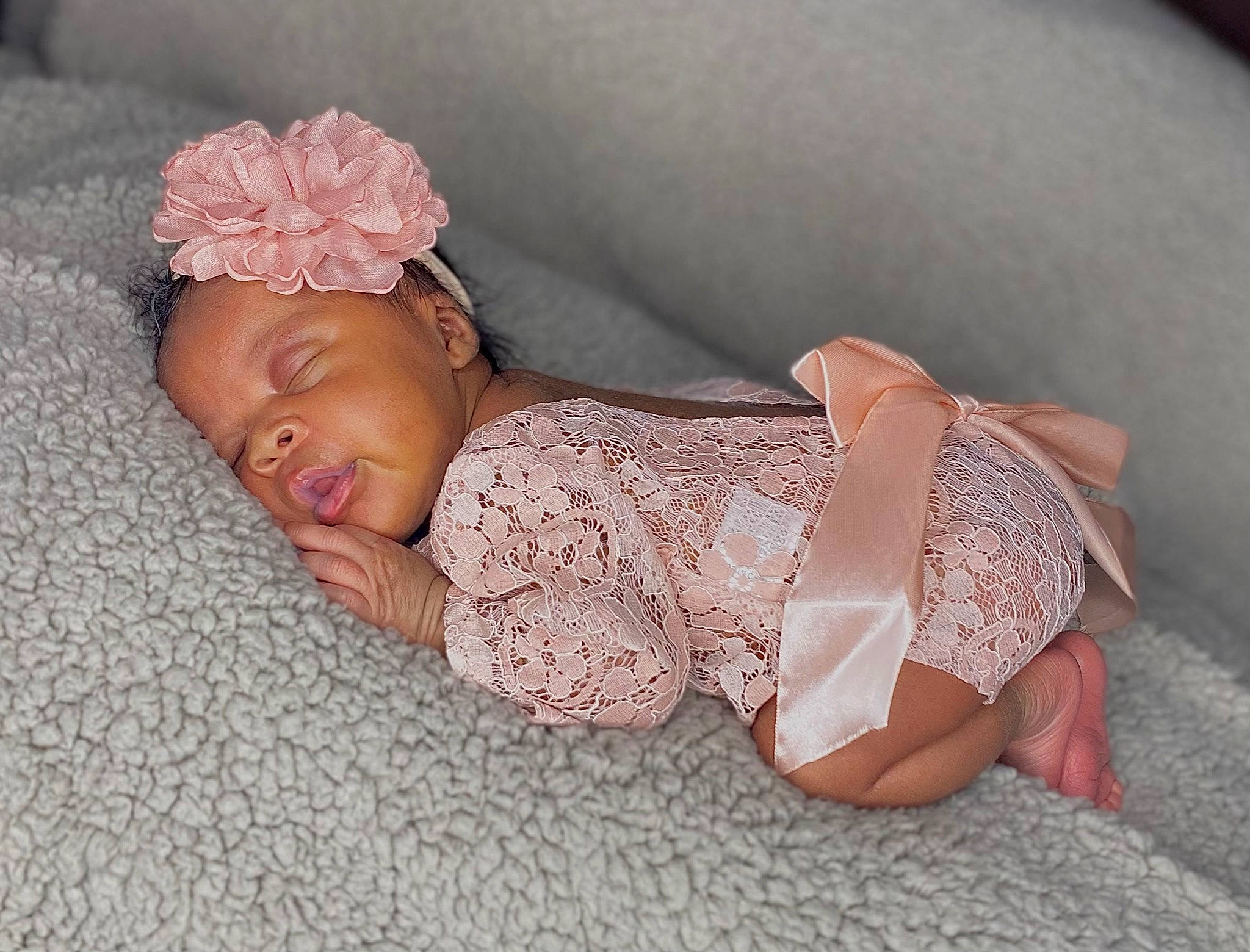 Choyce is registered to the contest to win money with this photo: baby, baby_toddler_clothing, child, comfort, embellishment, finger, flooring, flower, hand, head, headband, headpiece, linens, nail, person, petal, pink, skin, sleeve, textile