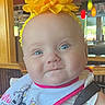 baby, bib, blue_eyes, child, colorful_lights, cute, date_overlay, digital_clock, face, happy, headband, high_chair, indoor, infant, portrait, restaurant, seatbelt, smile, wooden_furniture, yellow_flower
