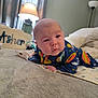 Asher joined the competition — help win amazing prizes! baby, infant, newborn, bed, blanket, pillow, lamp, basket, onesie, space_print_onesie, face, eyes, hands, tummy_time, cozy, indoors, soft_texture, portrait, curious_expression, bedroom