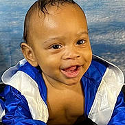 Zae'Vion joined the competition — help win amazing prizes! baby, child, smiling, blue_jacket, white_trim, infant, happy, face, portrait, cute, young_child, skin, hand, eyes, mouth, teeth, background, clothing, indoor, closeup