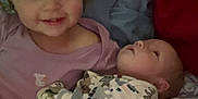 Brooklynn is registered to the contest to win money with this photo: baby, toddler, child, pajamas, dinosaur_print, bed, blanket, smile, face, sleepwear, cute, infant, sibling, family, happy, indoor, person, cozy, cuddle, soft