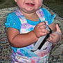 Brooklynn joined the competition — help win amazing prizes! toddler, child, indoor, smiling, standing, overalls, tie_dye, blue_shirt, hairbrush, toy, rug, carpet, furniture, household, person, happy, curious, face, hands, room