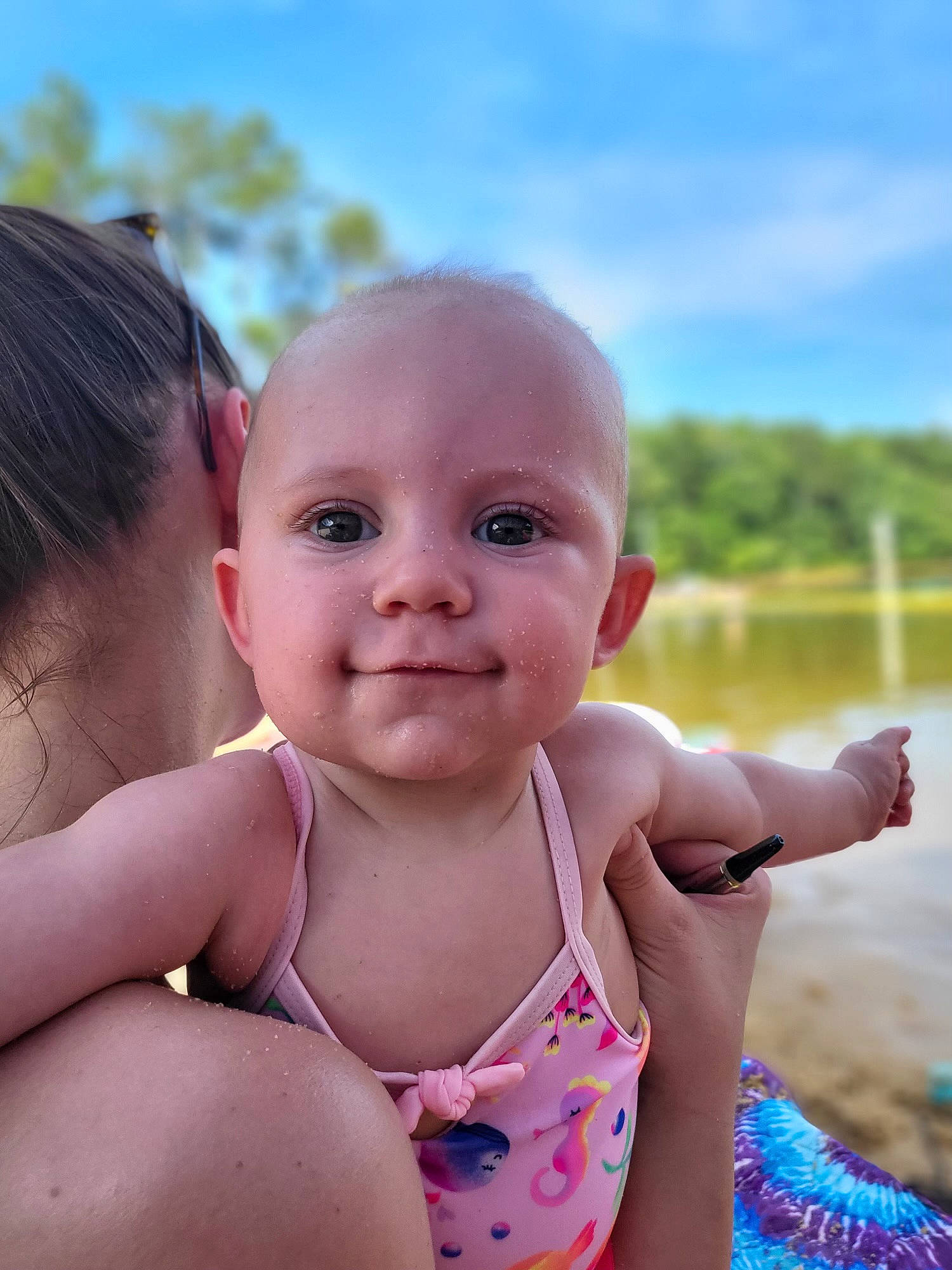 Ayla is registered to the contest to win money with this photo: baby, baby_toddler_clothing, cheek, finger, fun, grass, happy, head, iris, leisure, lip, people_in_nature, person, pink, skin, sky, smile, summer, swimwear, toddler