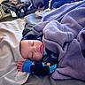 George is registered to the contest to win money with this photo: baby, bed, blanket, car_seat, child, comfort, cozy, fabric, face, fan, hand, home, indoor, infant, pajamas, peaceful, person, rest, sleeping, soft