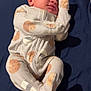 baby, infant, pajamas, cookie_pattern, sleepwear, lying_down, bed, blanket, comfort, face, skin, newborn, person, cute, small, indoors, clothing, relaxed, young_child, resting