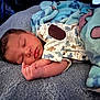 baby, sleeping, blanket, onesie, animal_print, infant, cozy, soft_texture, resting, cute, child, peaceful, indoors, closeup, portrait, hand, face, eyelashes, newborn, sleep