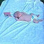 american_flag, baby, barefoot, blanket, diaper, feet, flag, grass, infant, laying_down, nature, newborn, outdoor, peaceful, person, resting, skin, small_flag, summer, white_blanket