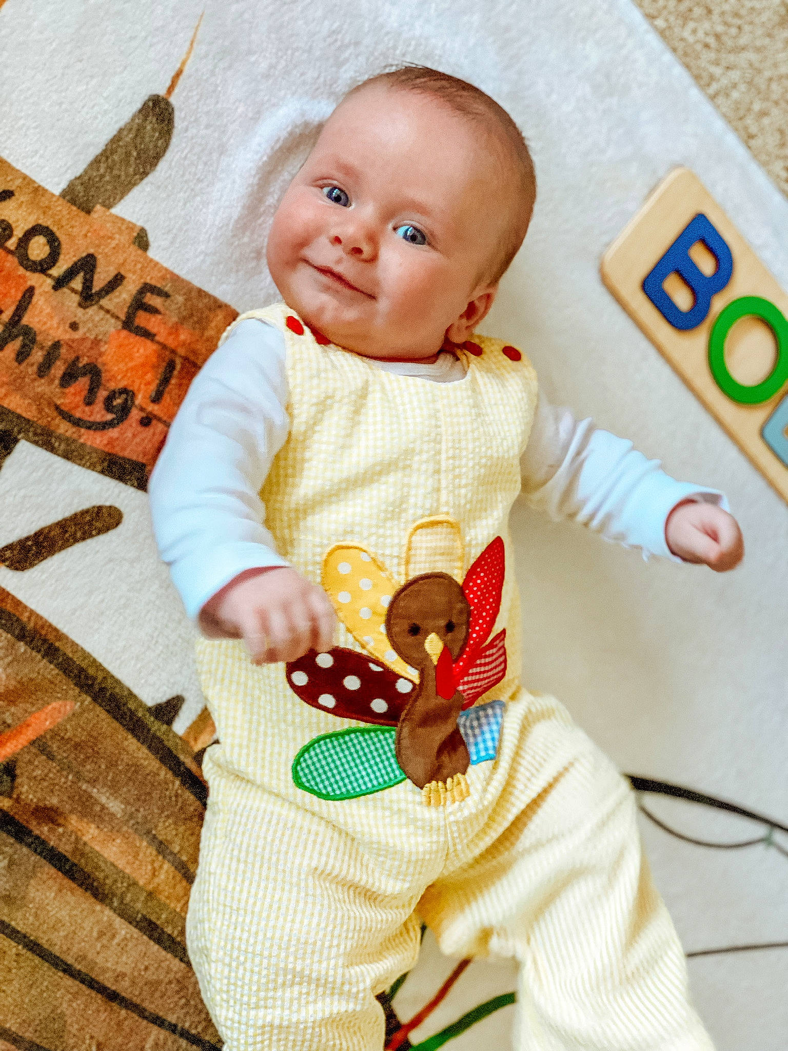Bodie is registered to the contest to win money with this photo: baby, baby_products, baby_toddler_clothing, child, doll, fawn, finger, happy, joy, linens, orange, pattern, person, product, skin, sleeve, smile, t_shirt, textile, toddler