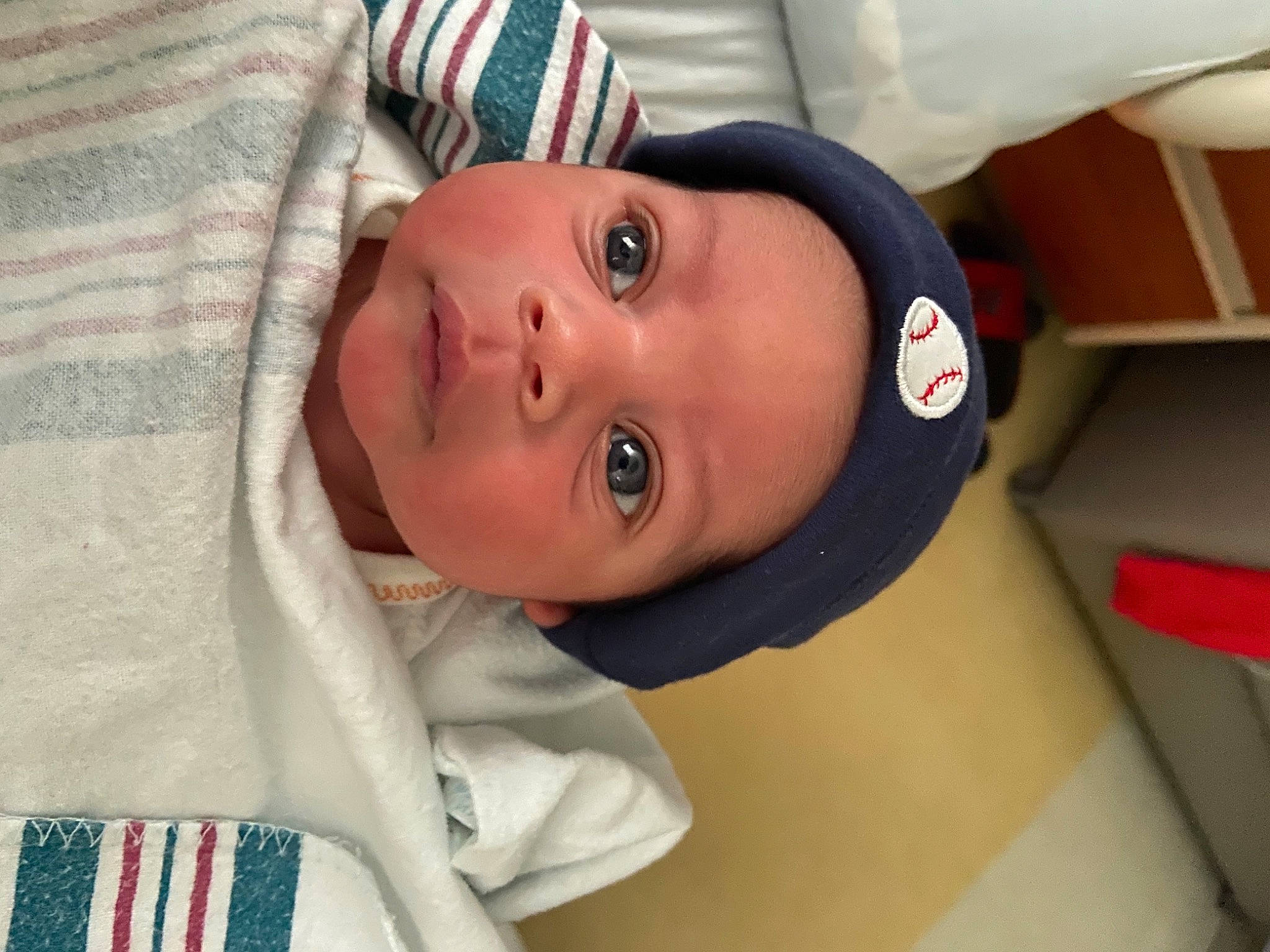 Ace is registered to the contest to win money with this photo: baby, baby_products, baby_toddler_clothing, cheek, child, comfort, event, eye, eyebrow, eyelash, hat, headwear, linens, lip, mouth, neck, nose, person, room, sleeve