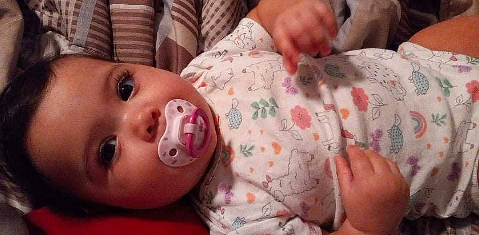 Novaleigh is registered to the contest to win money with this photo: baby, baby_toddler_clothing, cheek, chin, eye, eyelash, finger, hand, happy, human, iris, lip, mammal, mouth, neck, nose, person, pink, skin, textile