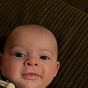 Wilder is registered to the contest to win money with this photo: baby, cheeks, child, closeup, cushion, cute, expression, eyes, face, indoors, infant, lying_down, person, portrait, skin, smile, soft_lighting, striped, texture, young