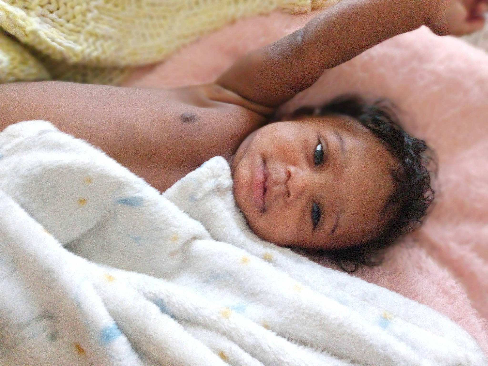 Tobiah is registered to the contest to win money with this photo: abdomen, baby, barechested, bedding, chest, child, close_up, comfort, eye, eyebrow, eyelash, fur, happy, linens, lip, nose, person, room, skin, smile