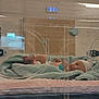 élyas a rejoint le concours — aidez-le/la à gagner de superbes lots ! newborn, baby, incubator, hospital, blanket, medical_equipment, infant, hat, lying_down, patient, healthcare, bed, small_feet, peaceful, wrapped, nursery, newborn_care, hospital_room, child, person