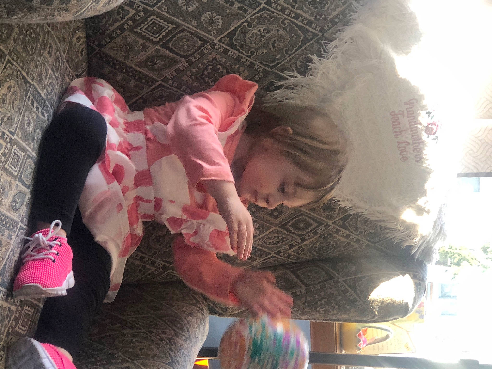 Isabella Rose is registered to the contest to win money with this photo: child, comfort, flesh, fun, happy, human_leg, leisure, magenta, person, pink, room, sitting, textile, toddler, tree, window