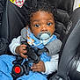 baby, car_seat, pacifier, child, blue_clothing, curly_hair, safety_buckle, infant, seatbelt, cute, indoor, person, small_hands, looking_up, protectplus, black_hair, car, sitting, young_child, adorable
