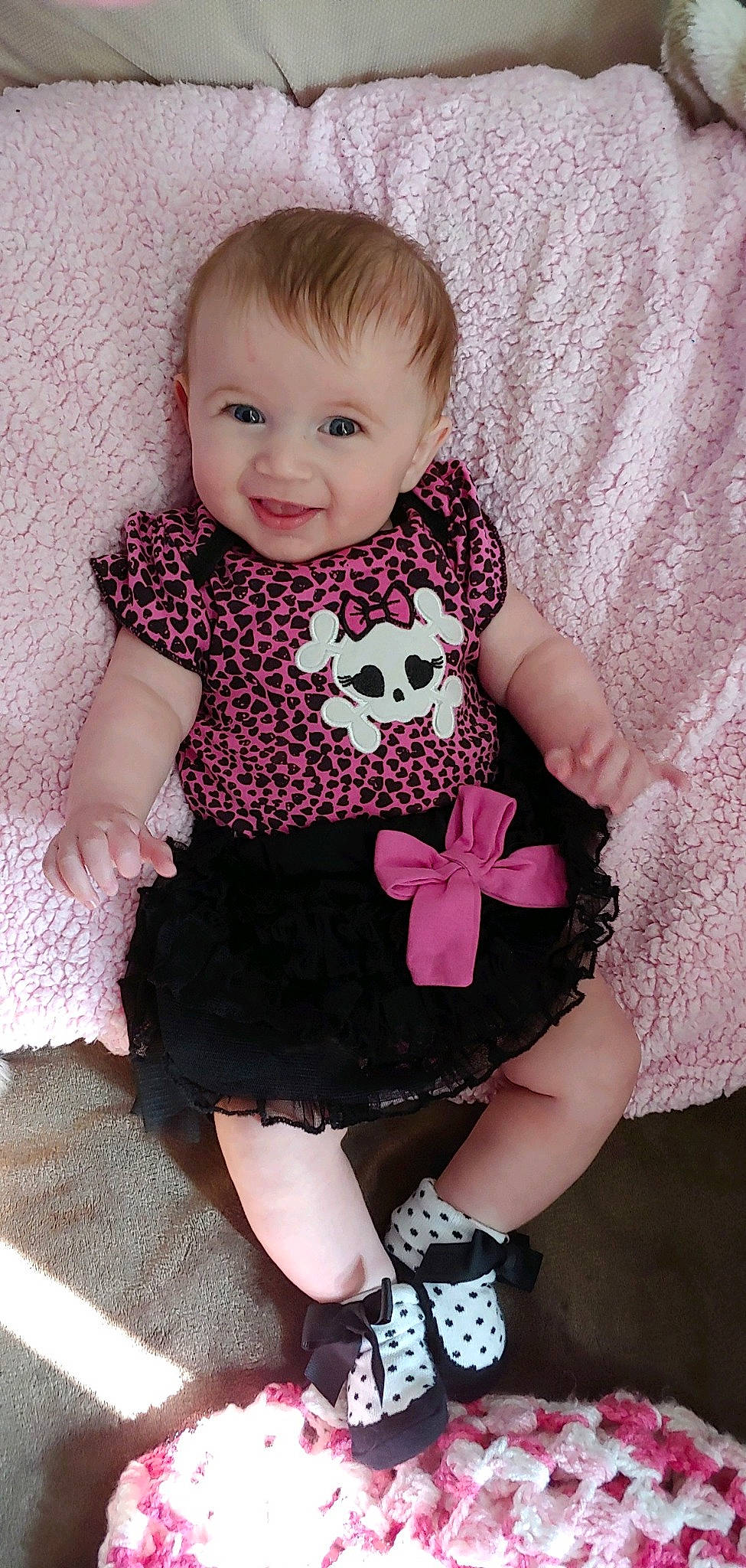 Ava is registered to the contest to win money with this photo: baby, baby_bloomers, baby_products, baby_toddler_clothing, cheek, child, child_model, dress, finger, joy, pattern, person, pink, product, sitting, skin, smile, toddler