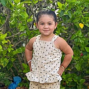 Jamilah joined the competition — help win amazing prizes! child, girl, smile, outdoor, greenery, plants, dress, patterned_clothing, portrait, happy, standing, nature, young_child, sunlight, casual, cute, person, fashion, summer, confident