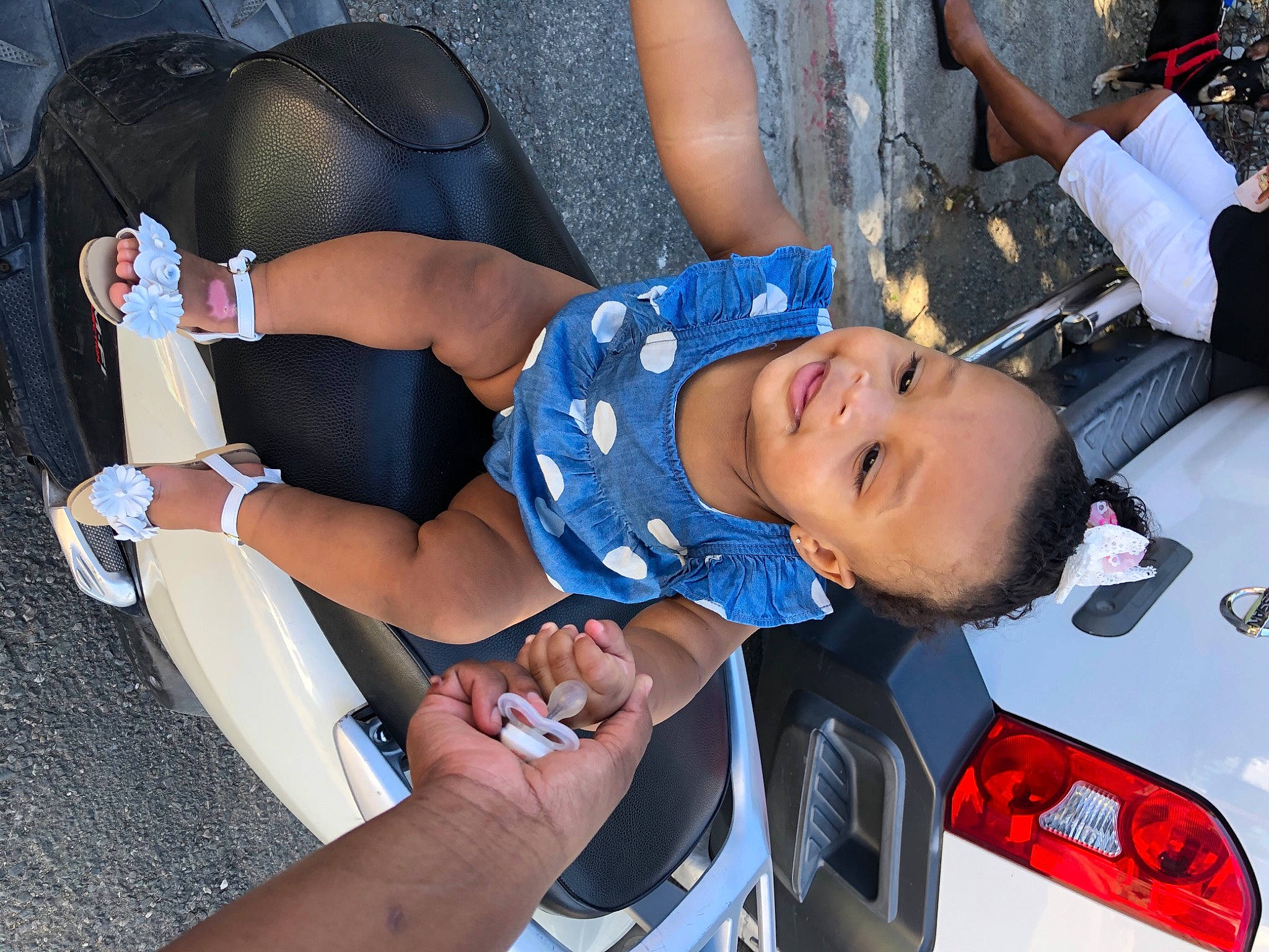 Amalia joined the competition — help win amazing prizes! automotive_exterior, automotive_lighting, bumper, car, dress, fun, hat, human_leg, joy, knee, lap, leisure, person, product, recreation, shoe, smile, sneakers, thigh, toddler