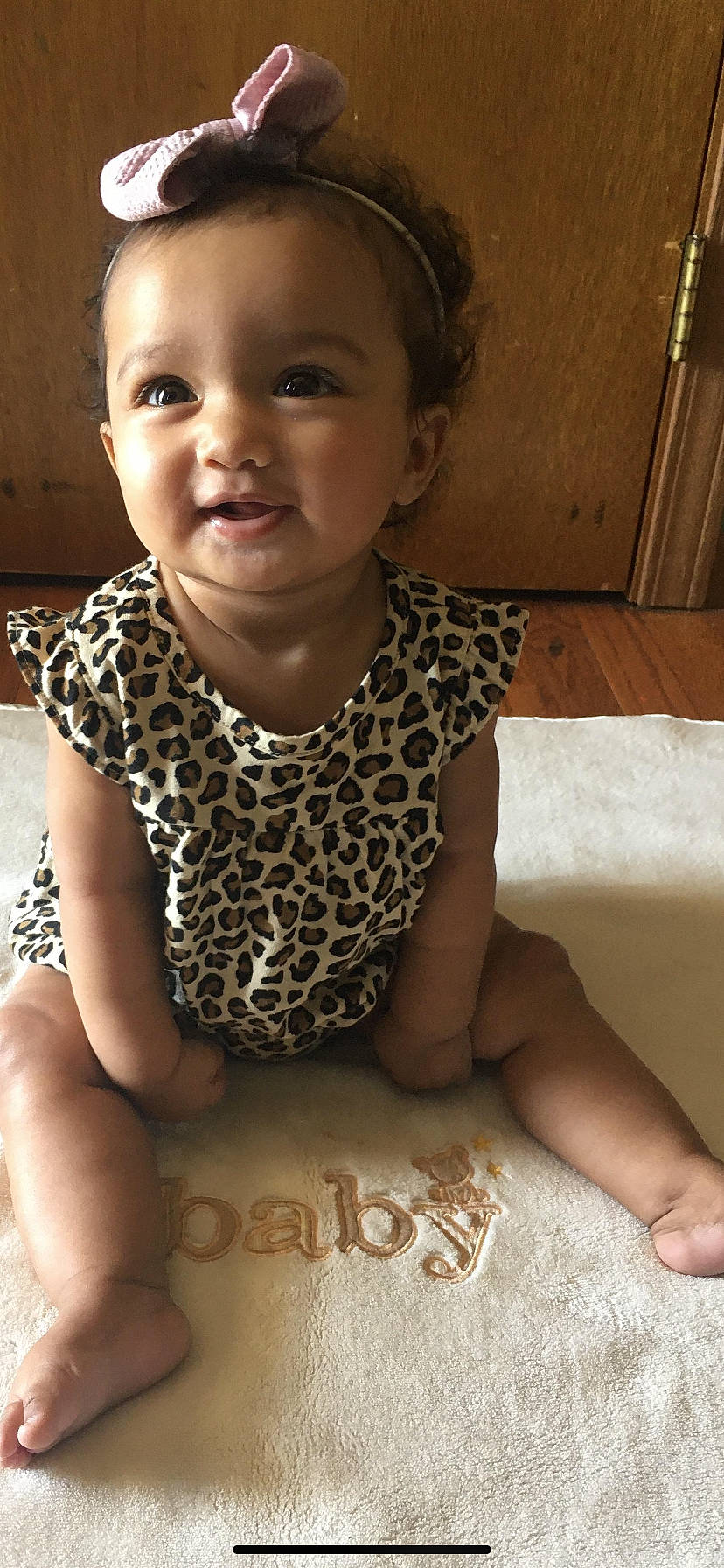 Aiyana is registered to the contest to win money with this photo: baby, baby_toddler_clothing, child, face, person, sitting, skin, smile, toddler, tummy_time