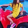 child, clothing, device, face, female, footwear, girl, grass, head, lawn, lawnmower, person, photography, plant, portrait, shoe, shorts, sitting, t_shirt, tool