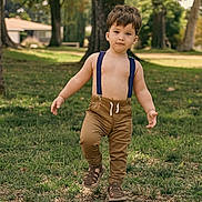 Aleks joined the competition — help win amazing prizes! toddler, child, park, outdoor, grass, trees, sunlight, walking, pants, suspenders, sandals, shirtless, nature, daylight, young_child, person, casual, summer, greenery, playful