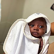 Zyaire is registered to the contest to win money with this photo: baby, towel, hooded_towel, infant, wrapped, person, skin, face, eyes, arm, cute, newborn, soft, cozy, indoors, child, portrait, expression, white, fabric