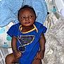 Zyaire joined the competition — help win amazing prizes! baby, infant, blue_onesie, blanket, pillow, bed, soft_toys, cute, child, portrait, indoors, sleeping_area, resting, newborn, cozy, clothing, person, skin, face, expression