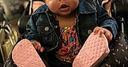 Ava joined the competition — help win amazing prizes! baby, infant, child, headband, flower, denim_jacket, car_seat, pink_shoes, footwear, cute, indoor, portrait, person, expression, curly_hair, clothing, seat, holding, focus, closeup