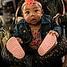 baby, infant, child, headband, flower, denim_jacket, car_seat, pink_shoes, footwear, cute, indoor, portrait, person, expression, curly_hair, clothing, seat, holding, focus, closeup
